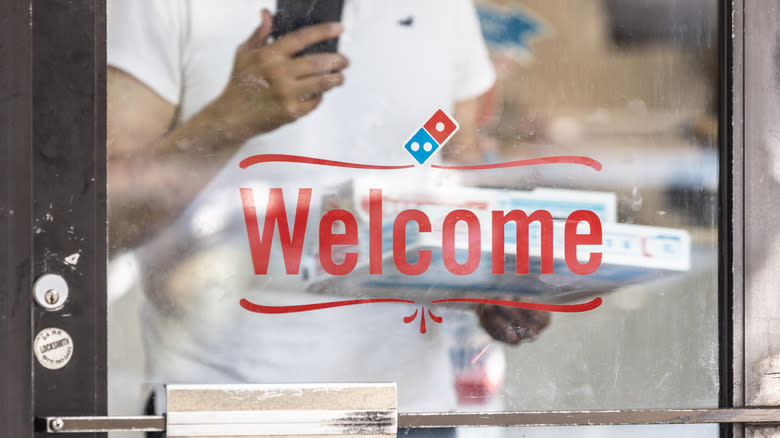 Customer on phone entering Domino's 