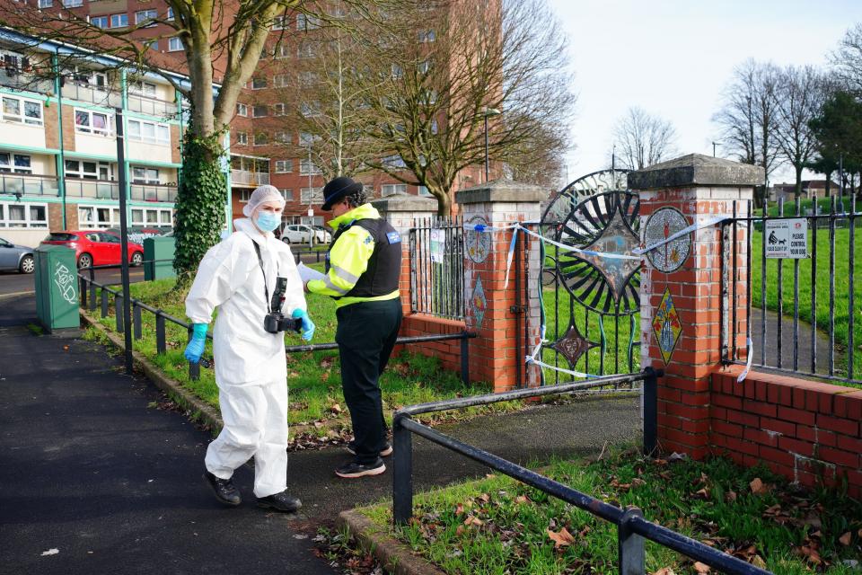 Investigators wearing white forensic suits were seen examining the scene and taking photographs on Thursday (PA)