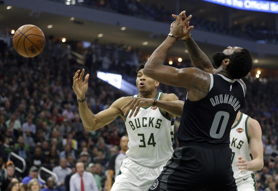 Detroit Pistons' Andre Drummond (0) and Milwaukee Bucks' Giannis Antetokounmpo (34) go for a loose ball during the first half of Game 2 of an NBA basketball first-round playoff series Wednesday, April 17, 2019, in Milwaukee. (AP Photo/Aaron Gash)