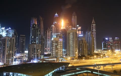 The fire can be seen amidst the Dubai skyline - Credit: Getty