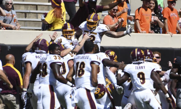 Central Michigan players celebrate after beating Oklahoma State on a last-second Hail Mary. (Getty)