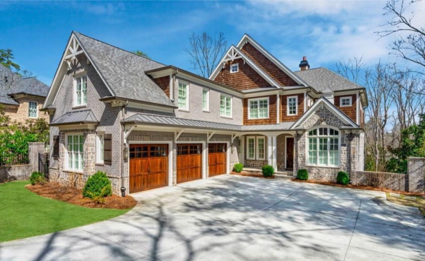 Built in 2014, the three-story home of more than 7,700 square feet draws the eye with an exterior of wood, stone and brick.