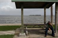 A man smokes a cigarrette at Parrish Park ahead of the arrival of Hurricane Dorian in Titusville