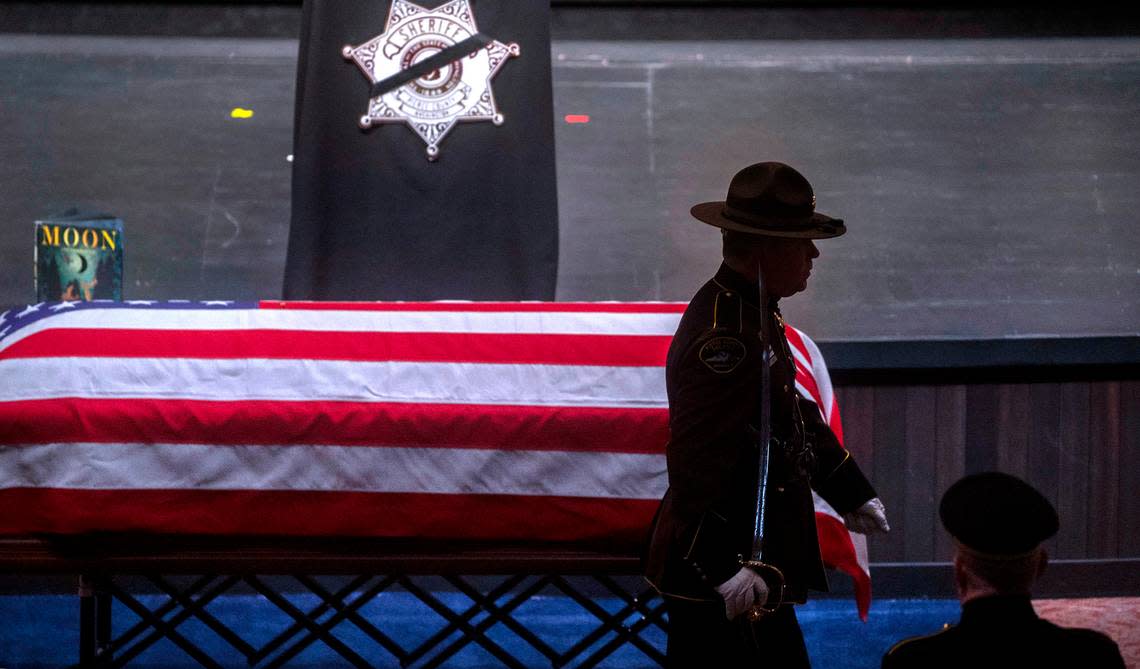 A color guard member passes the casket of Dom Calata during a celebration of life ceremony for the slain sheriff’s deputy at Church For All Nations in Parkland on March 25, 2022.