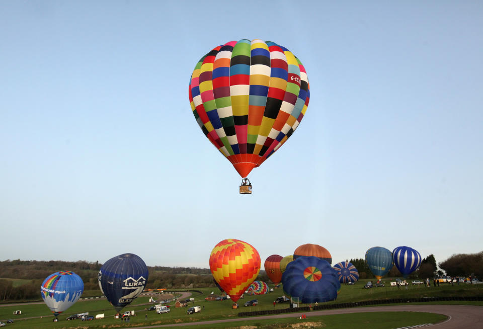 WOOTTON, UNITED KINGDOM - APRIL 07: Hot air balloons depart from Lydden Hill race circuit near Canterbury to take part in a mass crossing of the Channel on April 7, 2011 in Wootton, England. 51 balloonists of various nationalities from across Europe took off from Kent making for Calais, France at about 7am. It is the first time a Guinness World Record bid has been made for "the largest group of hot air balloons to make the Channel crossing". (Photo by Oli Scarff/Getty Images)