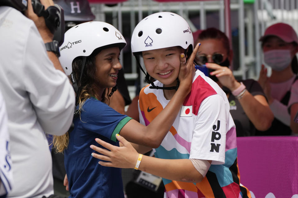 Silver medalist Rayssa Leal of Brazil, left, congratulates gold medal winner Momiji Nishiya of Japan after winning the women's street skateboarding finals at the 2020 Summer Olympics, Monday, July 26, 2021, in Tokyo, Japan. (AP Photo/Ben Curtis)