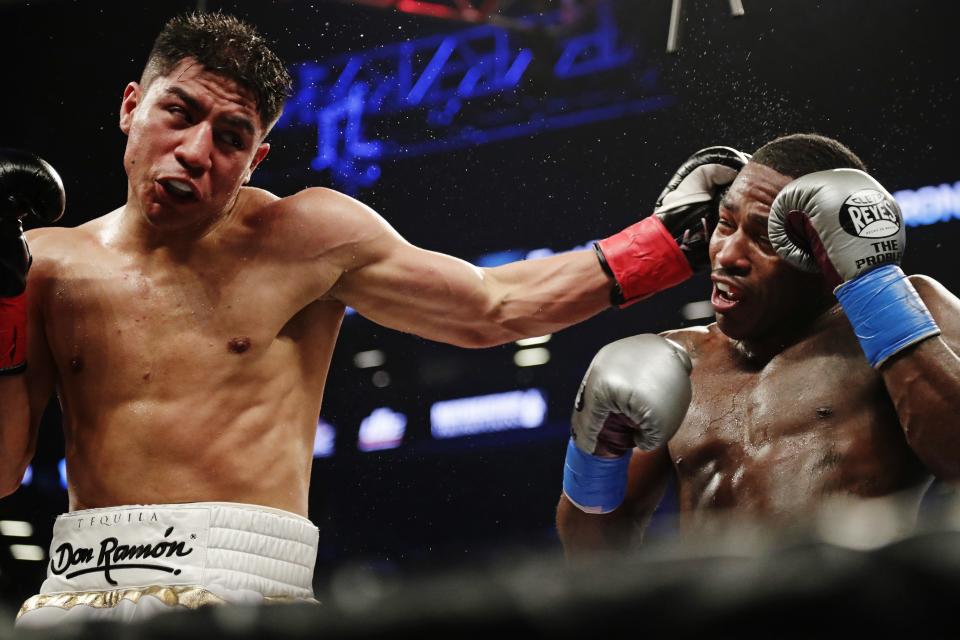 Jessie Vargas, left, punches Adrien Broner during the fourth round of their welterweight boxing match April 21, 2018, in New York. (AP)