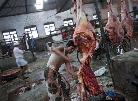 A butcher cuts up portions of beef for sale in an abattoir at a wholesale market in Mumbai in this June 2, 2011 file photo. REUTERS/Danish Siddiqui/Files