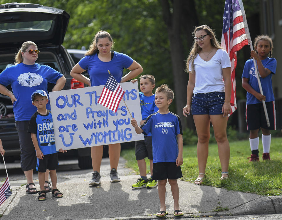 <p>Mourners line the street after the funeral of Otto Warmbier, Thursday, June 22, 2017, in Wyoming, Ohio. (Photo: Bryan Woolston/AP) </p>