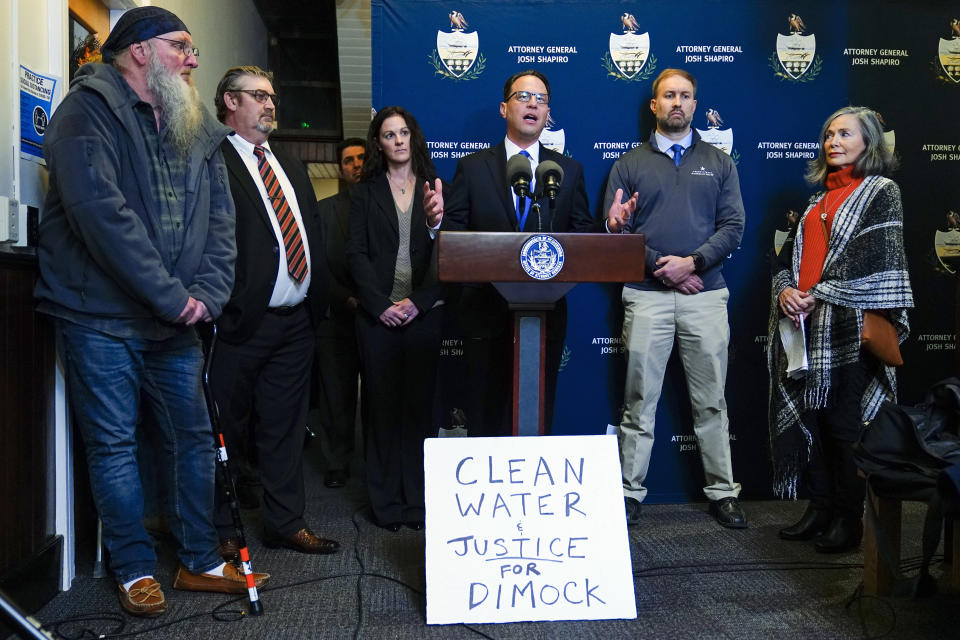 FILE - Pennsylvania Attorney General Josh Shapiro, center, speaks with members of the media during a news conference at the Susquehanna County District Courthouse in Montrose, Pa., Tuesday, Nov. 29, 2022. A year after pleading no contest to criminal charges, Coterra Energy Inc., one of Pennsylvania’s biggest natural gas companies, is poised to drill and frack in the rural community where it was banned for a dozen years over accusations it polluted the water supply. (AP Photo/Matt Rourke, File)