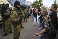 A woman argues with a police officer during an opposition rally to protest the official presidential election results in Minsk, Belarus, Saturday, Sept. 26, 2020. Hundreds of thousands of Belarusians have been protesting daily since the Aug. 9 presidential election. (AP Photo/TUT.by)
