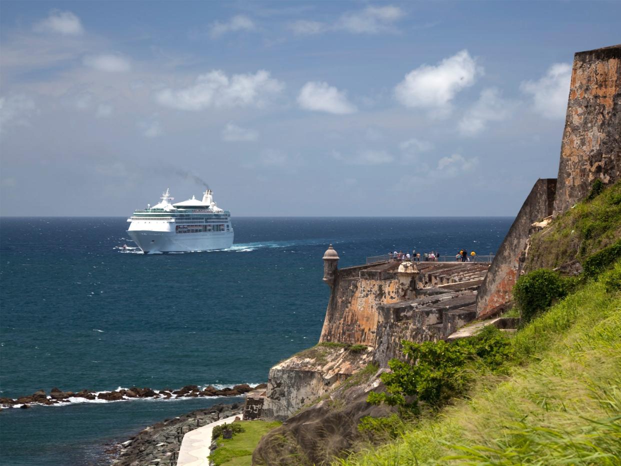 A cruise ship enters San Juan Harbor, passing the fortress of El Morro, in Puerto Rico.