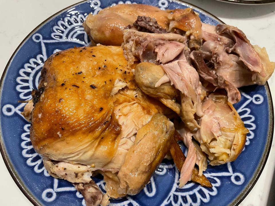 Pieces of Walmart rotisserie chicken on a blue plate