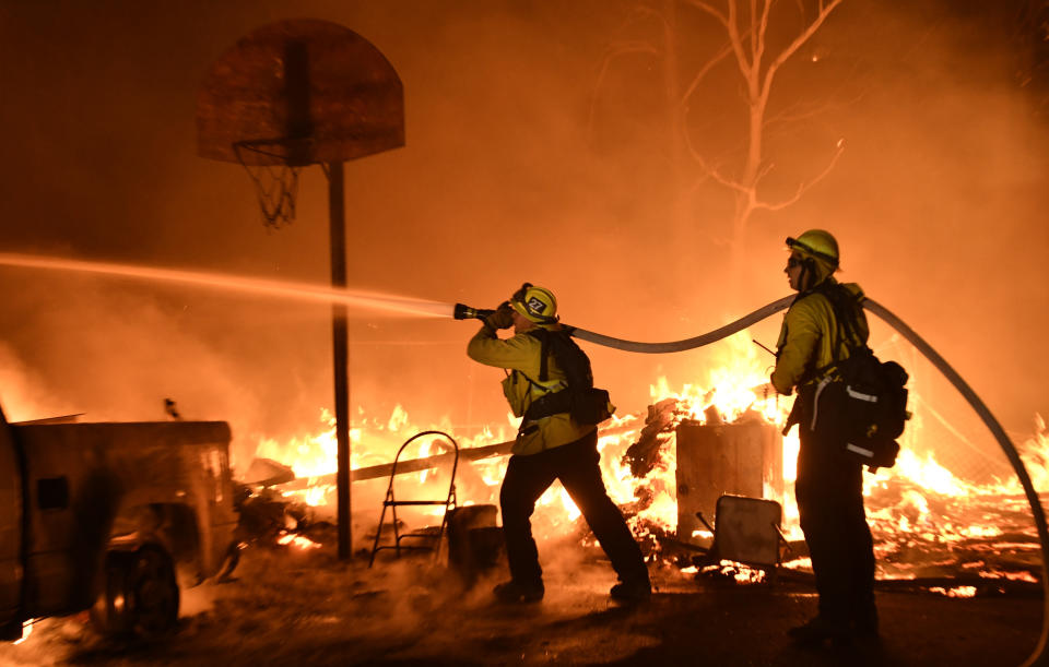 <p>Firefighters battle a santa ana wind-driven brush fire called the Thomas fire that exploded to 31,00 acres with zero percent containment overnight Monday into early Tuesday morning, according to Ventura County fire officials in Santa Paula, Calif., on Dec. 4, 2017. (Photo: Gene Blevins via ZUMA Wire) </p>