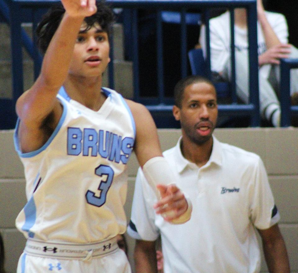 Bartlesville High's Aadhi Ayyappan, left, signals a play while Bruin head coach Clent Stewart looks on during action last season.