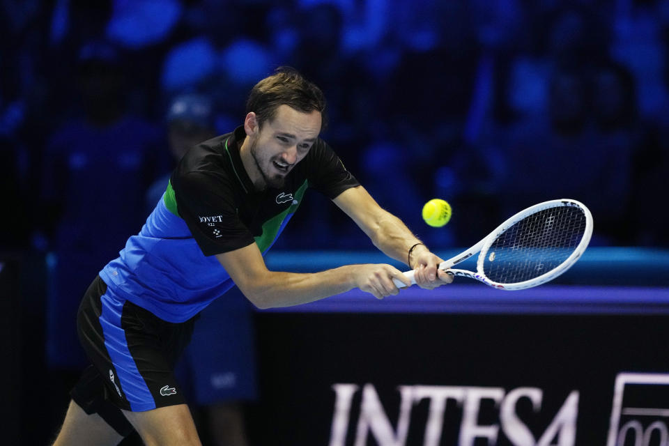 Russia's Daniil Medvedev returns the ball to Spain's Carlos Alcaraz during their singles tennis match of the ATP World Tour Finals at the Pala Alpitour, in Turin, Italy, Friday, Nov. 17, 2023. (AP Photo/Antonio Calanni)