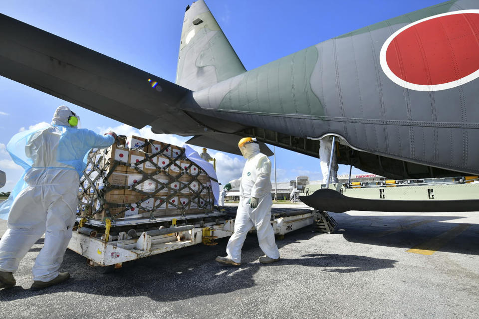 In this photo provided by Japan Joint Staff Office, a Japan Air Self-Defense Force aircraft arrives at Tonga's Fua'amotu International Airport, near Nuku'alofa to deliver aid after an undersea volcano eruption, Saturday, Jan. 22, 2022. (Japan Joint Staff Office via AP)