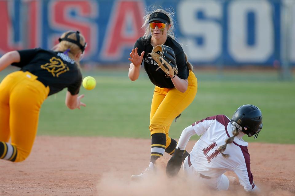 Caddo's Kadey Lee McKay waits for the ball as Ripley's Kendyl Overton slides safely to second in the Class 2A slowpitch softball state championship game on May 3. Caddo won 18-8.