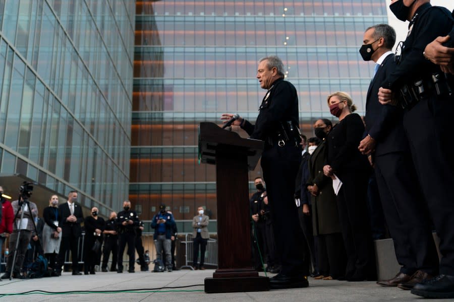 FILE – Los Angeles Police Chief Michel Moore, center, speaks during a news conference as he is joined by Mayor Eric Garcetti, second from right, outside the Los Angeles Police Headquarters Thursday, Dec. 2, 2021, in Los Angeles. Moore announced his retirement Friday, Jan. 12, 2024, in an unexpected departure as the head of one of the nation’s largest law enforcement agencies. (AP Photo/Jae C. Hong, File)