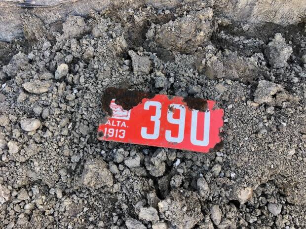 A City of Calgary crew working on the downtown flood barrier found a 108-year-old license plate while excavating on the banks of the Bow River this week. (City of Calgary - image credit)