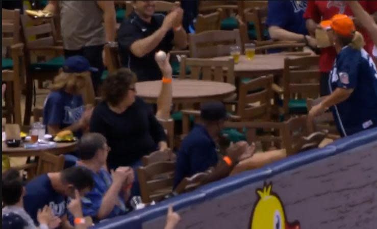 A Tigers fan shows off his souvenir after tumbling over some chairs at Tropicana Field. (MLB.TV)