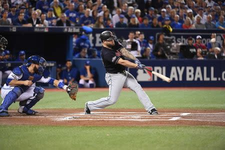 Oct 17, 2016; Toronto, Ontario, CAN; Cleveland Indians first baseman Mike Napoli (26) hits a RBI-double scoring designated hitter Carlos Santana (not pictured) against Toronto Blue Jays catcher Russell Martin (left) during the first inning in game three of the 2016 ALCS playoff baseball series at Rogers Centre. Mandatory Credit: Nick Turchiaro-USA TODAY Sports