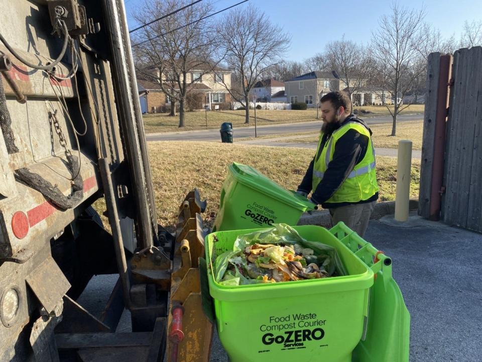 Michael Little, a compost operator with GoZERO Accessible Food Waste Services, picks up discarded food scraps to be converted to compost March 2 at Sunny 95 Park. Upper Arlington has three food waste drop-off sites and launched a curbside food waste collections program in April. The pilot program will serve up to 700 households through September 2023.