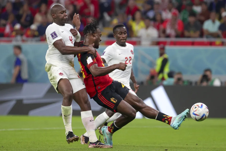 Canadian Kamal Miller, Belgium&#39;s Michy Batshuayi, scoring the 1-0 goal and Canadian Richie Laryea pictured in actin during a soccer game between Belgium&#39;s national team the Red Devils and Canada, in Group F of the FIFA 2022 World Cup in Al Rayyan, State of Qatar on Wednesday 23 November 2022.
BELGA PHOTO VIRGINIE LEFOUR (Photo by VIRGINIE LEFOUR / BELGA MAG / Belga via AFP) (Photo by VIRGINIE LEFOUR/BELGA MAG/AFP via Getty Images)