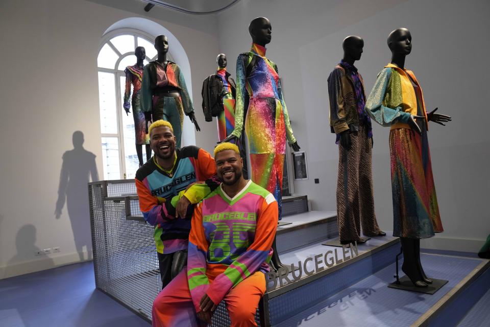 From left, designers Glen and Bruce Proctor pose for portraits in front of their creations at the fashion hub part of the women's Fall-Winter 2024-25 collection presented in Milan, northern Italy, Wednesday, Feb. 21, 2024. (AP Photo/Antonio Calanni)