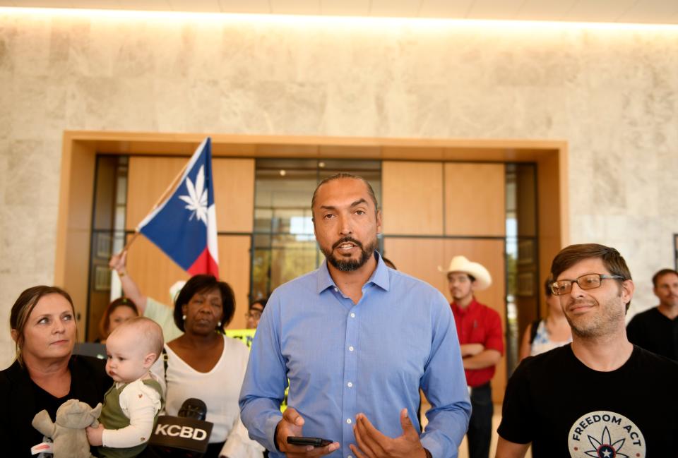 Adam Hernandez, center, speaks to members of the media before the Freedom Act Lubbock movement delivers petition signatures to the Lubbock city secretary Oct. 17 at Citizens Tower.