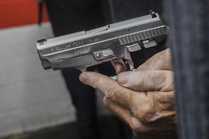 John Deloca, owner of Seneca Sporting Range, prepares to fire his 9mm semi-automatic handgun during a shooting demonstration at his gun range, Thursday, June 23, 2022, in New York. Deloca said he welcomes the Supreme Court ruling that Americans have a right to carry firearms in public for self-defense, striking down a New York gun law. (AP Photo/Bebeto Matthews)