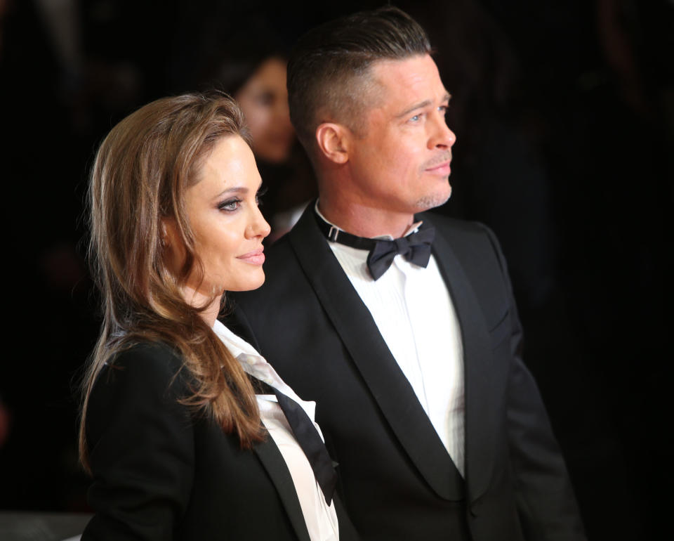 Actors Angelina Jolie and Brad Pitt pose for photographers on the red carpet at the EE British Academy Film Awards held at the Royal Opera House on Sunday Feb. 16, 2014, in London. (Photo by Joel Ryan/Invision/AP)