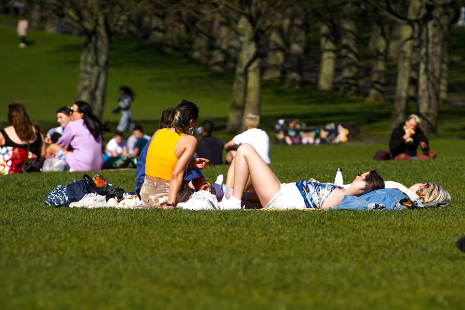 Members of the public enjoy the hot weather in Hyde Park, Leeds. (PA)