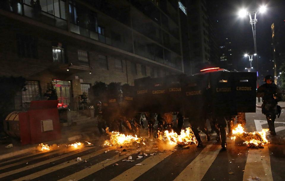 Military policemen advance ahead during a protest against the 2014 World Cup, in Sao Paulo