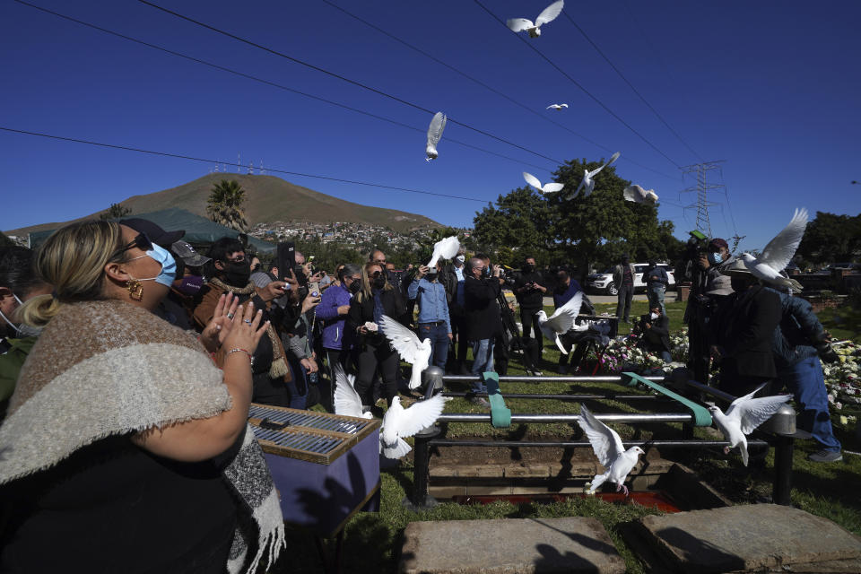 Renee Maldonado, a niece of murdered journalist Lourdes Maldonado, shouts "fly free auntie," as doves are released during her burial service at the Monte de los Olivos cemetery in Tijuana, Mexico, Thursday, Jan. 27, 2022. Maldonado, who was shot dead in her car when arriving home on Sunday, Jan. 23, was the third journalist killed in Mexico this year and the second in a space of two weeks in the border town of Tijuana. (AP Photo/Marco Ugarte)