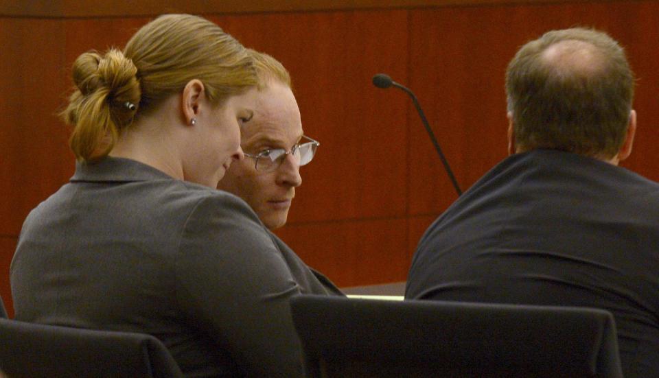 Eric Millerberg, center, and his defense attorneys Haylee Mills, left, and Randall Marshall, right, listen to opening statements by Deputy Weber County prosecuting attorney Chris Shaw, Wednesday, Feb. 12, 2014, in Ogden, Utah. Millerberg has been charged with injecting his 16-year-old baby sitter, Alexis Rasmussen, with a fatal dose of heroin and methamphetamine, then taking his wife and infant daughter along to dump Rasmussen's body near a river. (AP Photo/The Salt Lake Tribune, Leah Hogsten, Pool)