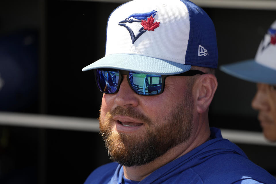 Toronto Blue Jays manager John Schneider stands in the duguout before a spring training baseball game against the Philadelphia Phillies Monday, March 4, 2024, in Dunedin, Fla. (AP Photo/Charlie Neibergall)