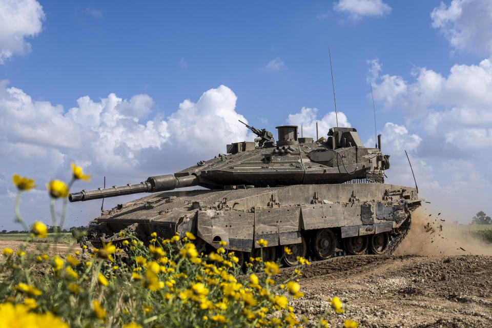 Israeli soldiers drive a tank on the border with Gaza Strip, in southern Israel, Tuesday, March 19, 2024. The army is battling Palestinian militants across Gaza in the war ignited by Hamas' Oct. 7 attack into Israel. (AP Photo/Ariel Schalit)