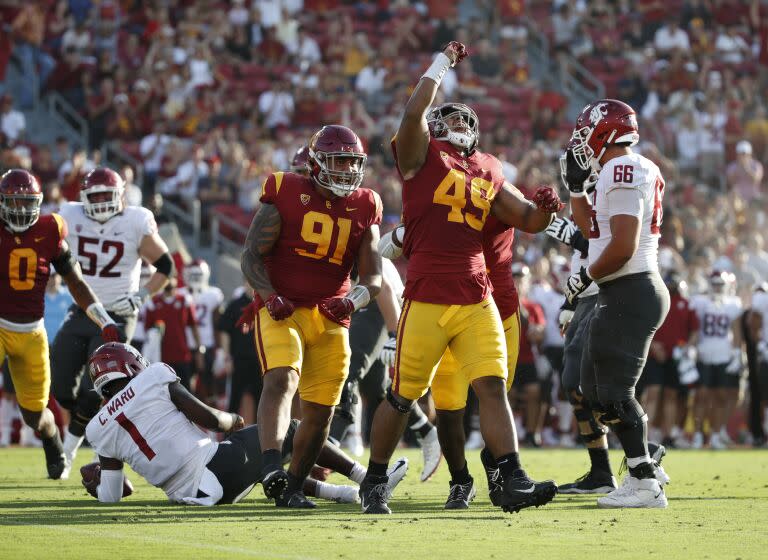 LOS ANGELES, CA - OCTOBER 8, 2022: USC Trojans defensive lineman Tuli Tuipulotu (49) and USC Trojans defensive lineman Brandon Pili (91)react after sacking Washington State Cougars quarterback Cameron Ward (1) in the first half at the Coliseum on October 8, 2022 in Los Angeles, California.(Gina Ferazzi / Los Angeles Times)