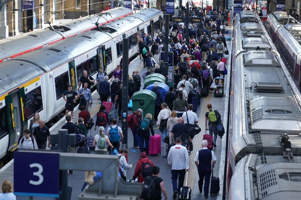 Passengers at London King’s Cross station (PA) (PA Wire)