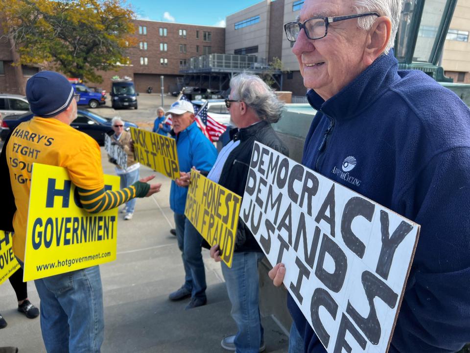 People protesting Harry Wait clash with his supporters outside the Racine County Courthouse on Friday.