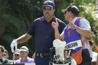 Phil Mickelson, left, talks with his caddy Tim Mickelson, right, on the 10th tee during the first round of the LIV Golf Team Championship at Trump National Doral Golf Club, Friday, Oct. 28, 2022, in Doral, Fla. (AP Photo/Lynne Sladky)