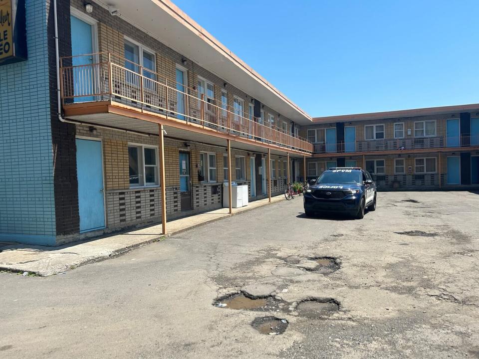 A police car sits outside the Motel St-Jacques on Tuesday, June 25, 2024. The authorities have seized the building.