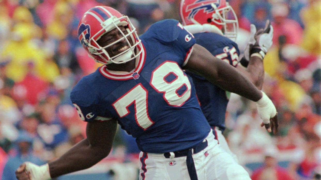 Mandatory Credit: Photo by Kevin Higley/AP/Shutterstock (6508999a)SMITH MADDOX Buffalo Bills defensive end Bruce Smith (78) celebrates a sack of New England Patriots quarterback Drew Bledsoe as Bills linebacker Mark Maddox, rear, applauds, during the third quarter of their game, at Rich Stadium in Orchard Park, N.