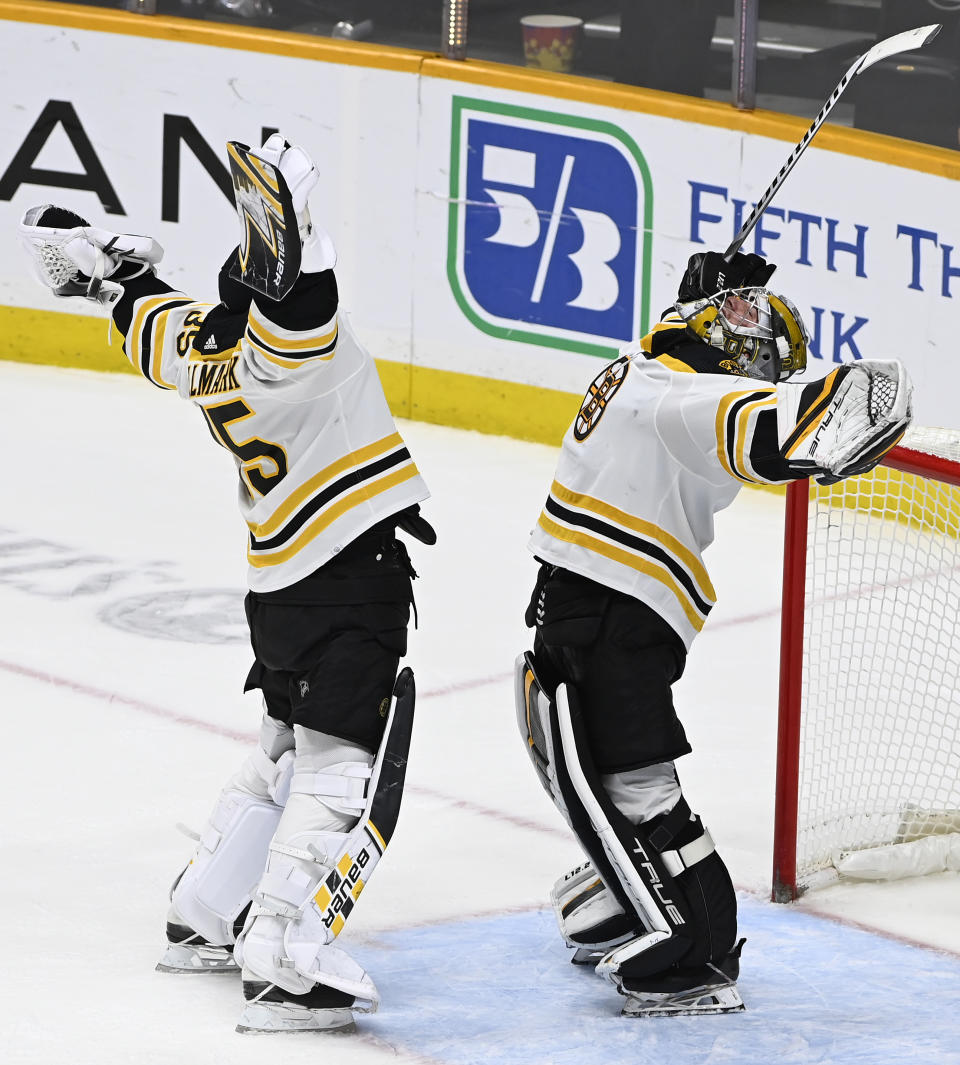 Boston Bruins goaltender Jeremy Swayman, right, celebrates with backup goaltender Linus Ullmark after the Bruins defeated the Nashville Predators in an NHL hockey game Thursday, Dec. 2, 2021, in Nashville, Tenn. (AP Photo/Mark Zaleski)