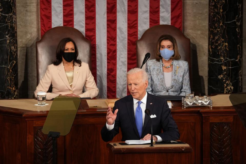 President Joe Biden, in front of Vice President Kamala Harris and House Speaker Nancy Pelosi, addresses a joint session of Congress on April 28, 2021.