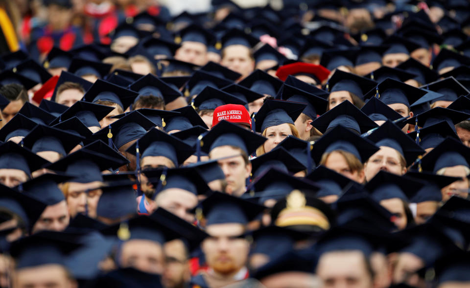 A graduate wears a Make America Great Again hat amidst a sea of mortar boards before the start of commencement exercises at Liberty University in Lynchburg, Virginia, U.S., May 11, 2019.  REUTERS/Jonathan Drake      TPX IMAGES OF THE DAY