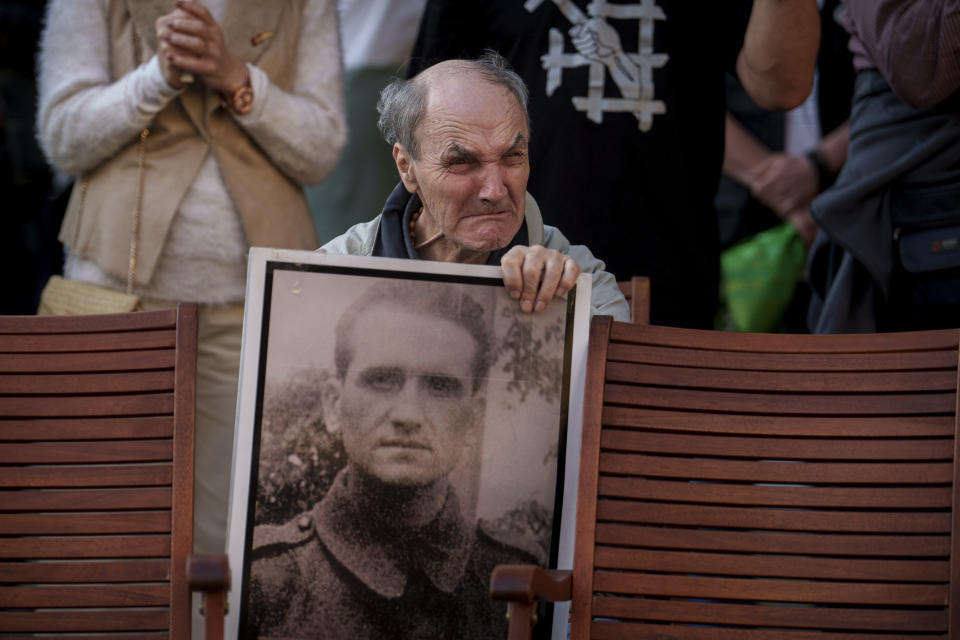An elderly man cries during a memorial for people who were imprisoned or perished in communist jails in Bucharest, Romania, Tuesday, May 14, 2024. On May 14, 1948, the Communist authorities arrested thousands of youngsters, intellectuals, clerics and others that were deemed a threat to the regime, some of whom were associated with the Iron Guard, a Romanian Nationalist pro-nazi organization, and jailed or sent them to labor camps where many died. (AP Photo/Vadim Ghirda)