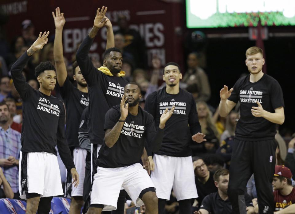 The San Antonio Spurs bench celebrates during overtime in an NBA basketball game against the Cleveland Cavaliers, Saturday, Jan. 21, 2017, in Cleveland. The Spurs won 118-115. (AP Photo/Tony Dejak)