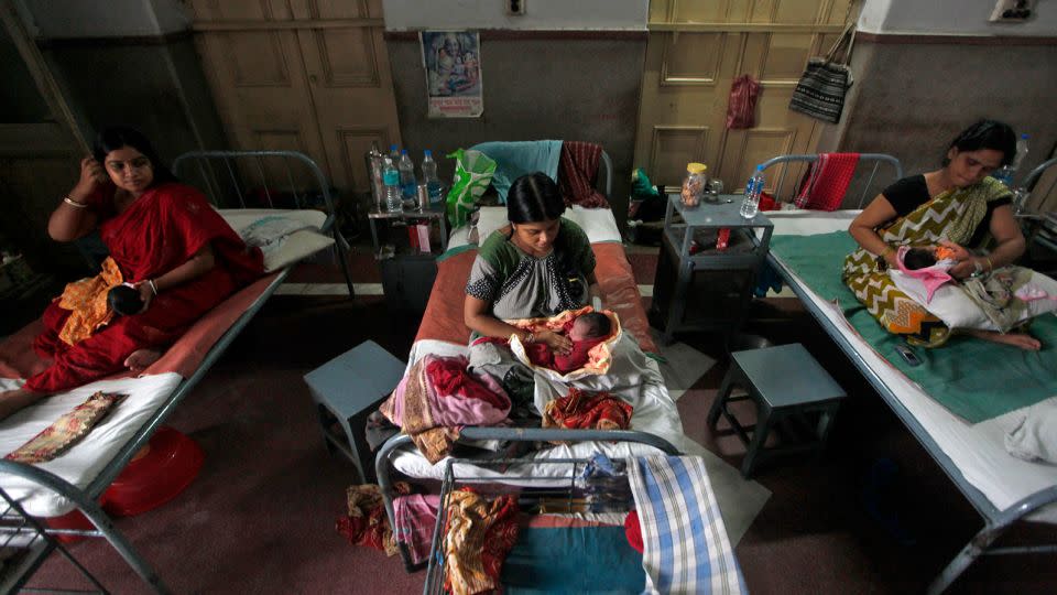 Mothers hold their newborn babies inside a maternity hospital during "World Population Day" in Kolkata July 11, 2012. - Rupak De Chowdhuri/Reuters/FILE